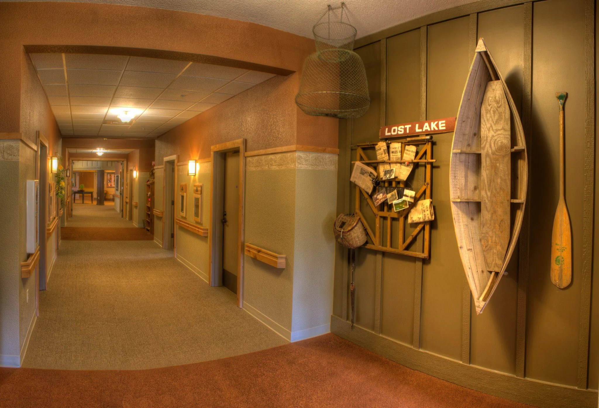 A hallway with various fishing and outdoor keepsakes hung on the walls