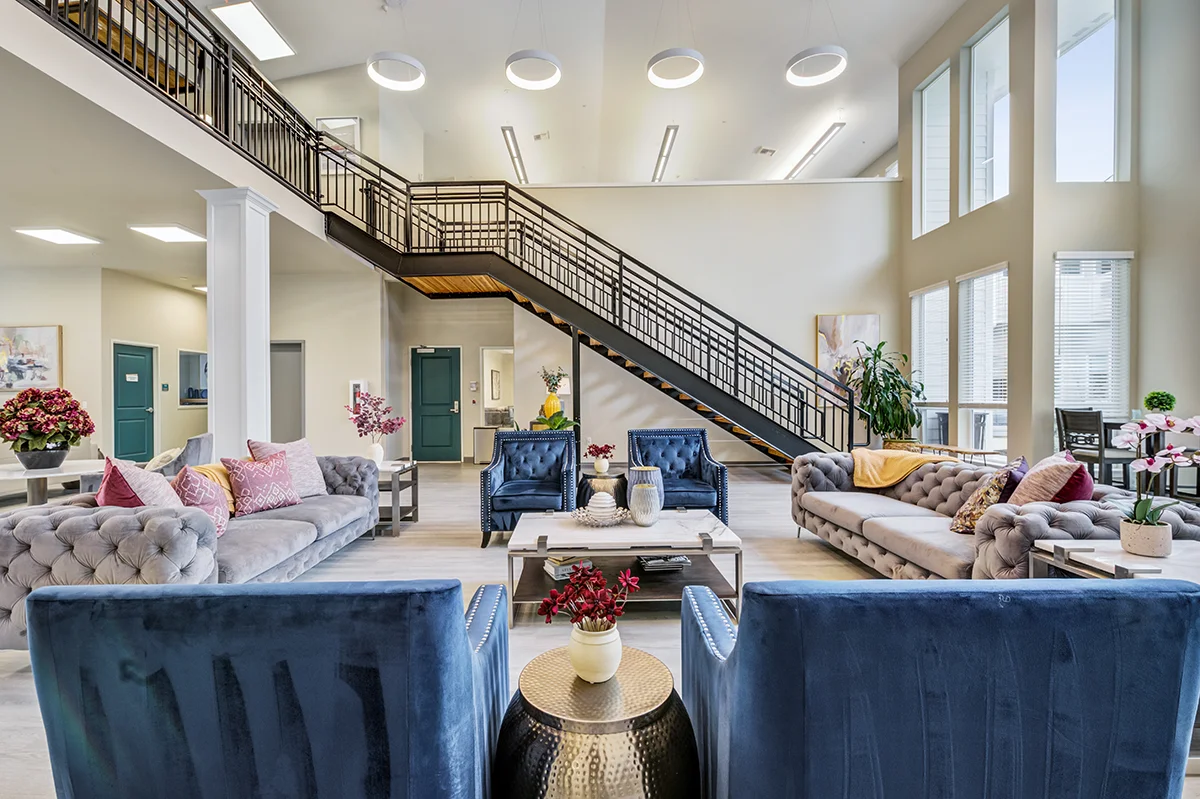 A sitting room with large windows and stylish furniture