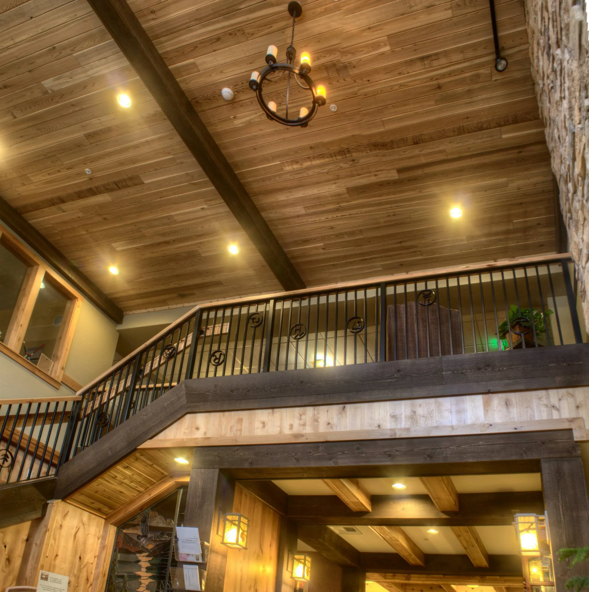 An indoor balcony with a wrought-iron rail