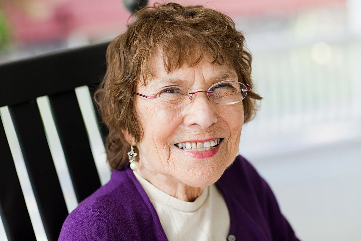 Senior woman grinning in a deck chair