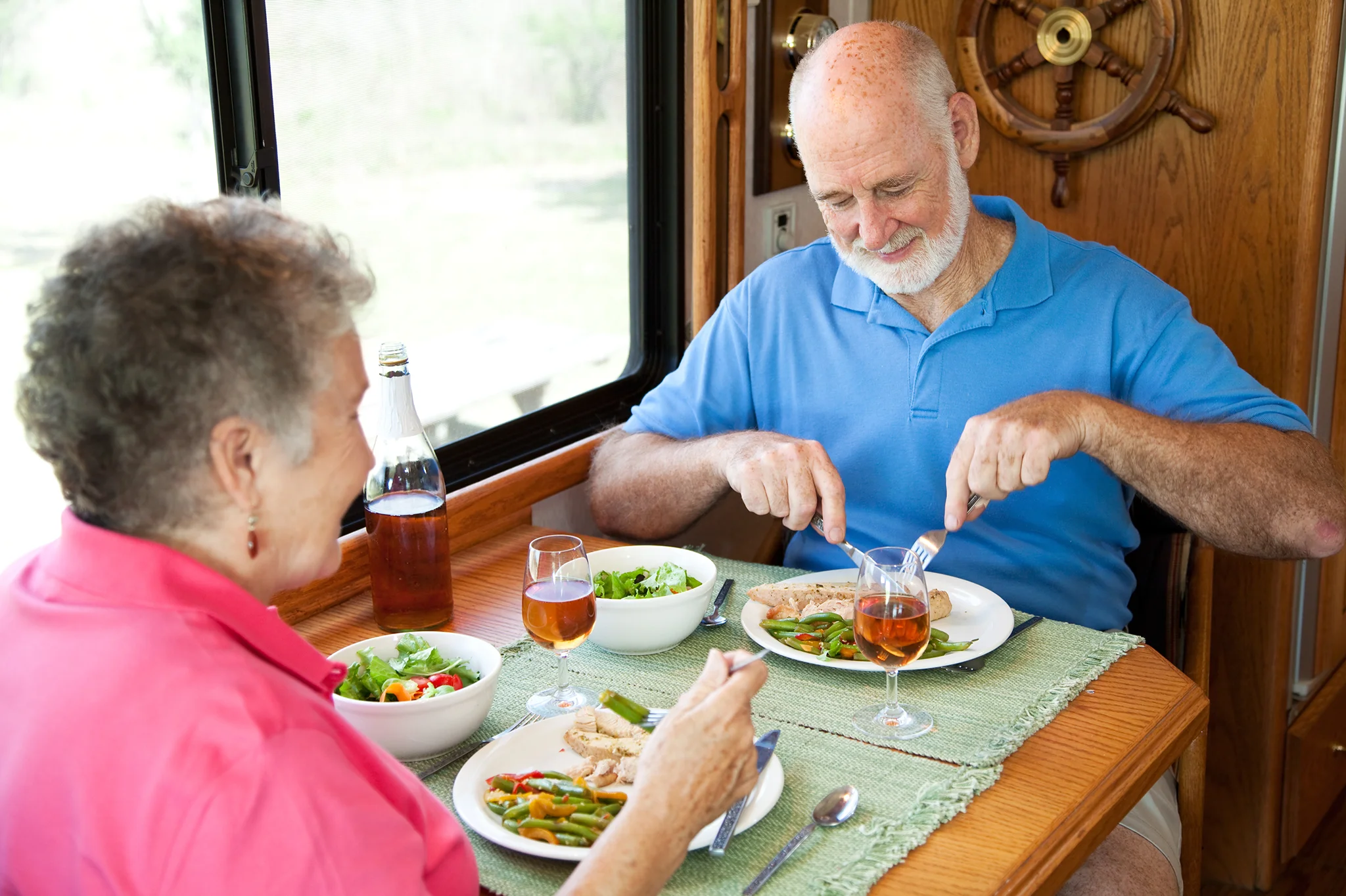 Senior couple smiling and enjoying dinner together